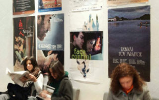 Viewers Reading about the Films presented in the Festival